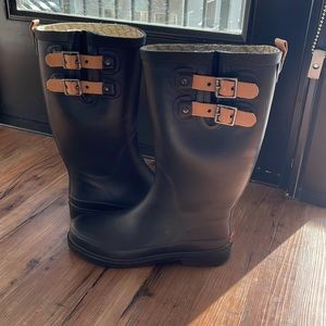 Black knee high Chooka rain boots with buckle details
